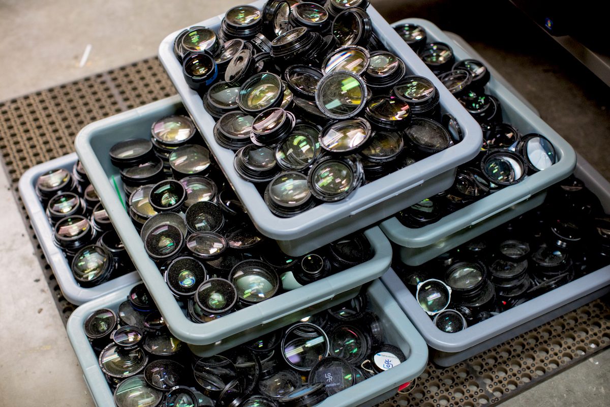 Discarded front elements. Each bin has around 125 front elements and weighs 30 to 50 pounds each. Lensrentals.com, 2016