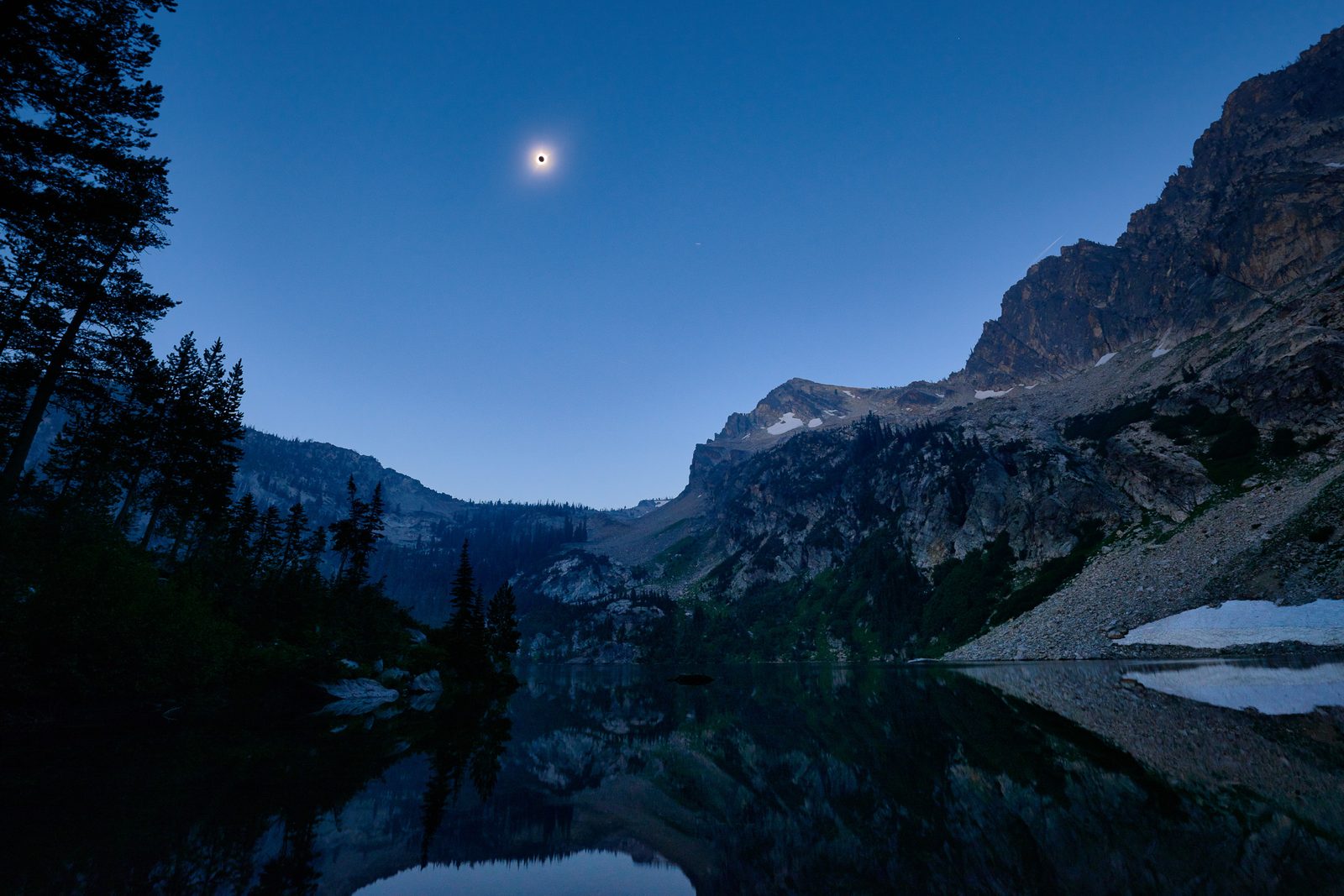 Solar Eclipse over Alpine Lake, in the Sawtooth Wilderness, Idaho