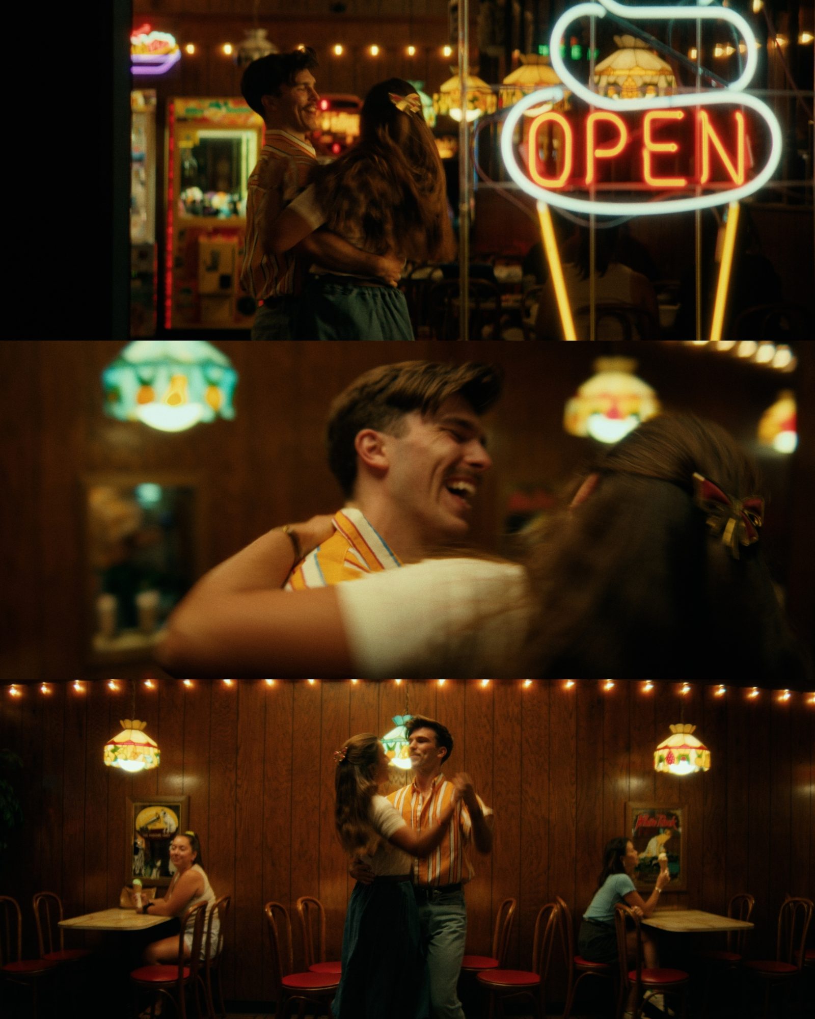Three film stills of a couple dancing in a warmly lit, wood-paneled retro diner beside a glowing neon “OPEN” sign.